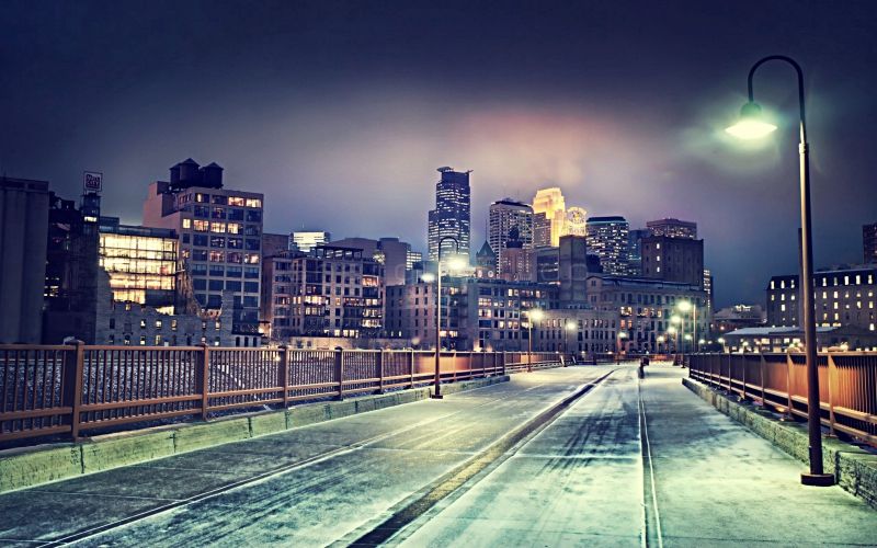 冬季的城市夜晚路上白白的一层薄薄的雪路灯明亮城市万家灯火通明